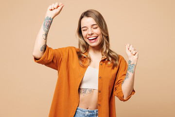 Young vibe vivid woman she wears orange shirt casual clothes doing winner gesture celebrate...