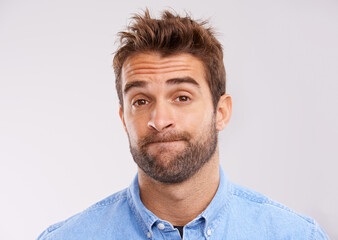 Obraz premium Studio, portrait and bored man with doubt, frustrated and confused on white background. Opinion, disappointment and face of person with decision, conflict or uncertainty for choice, news or ideas