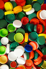 Close up of red, white, blue, yellow and green caps from plastic bottles. plastic collection. copy space. view from above . recycling
