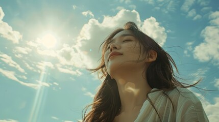 beautiful Japanese woman closes her eyes while enjoying the sunny weather - obrazy, fototapety, plakaty