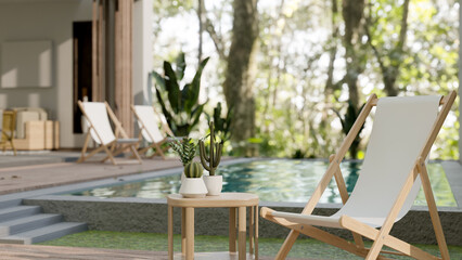 A lounge beach chair and a side table by the pool in a beautiful contemporary pool villa home.