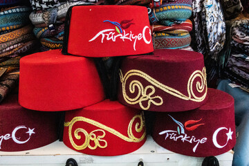 Fototapeta premium Taqiyah, traditional oriental rounded scullcaps at Bazaar, seen at a souvenir shop at the old town of Antalya, Turkey