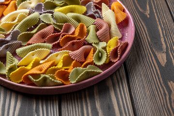 Colorful pasta background. Top view of five colors pasta shells .Heap of colorful spiral pasta,macaroni texture.