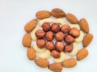 Almonds, cashew nuts and hazelnuts on bright background.