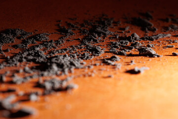 Close up of ashes and its shadows on the orange floor for graphic and web design use 