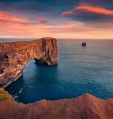 Magnificent summer sunset on Dyrholaey arch. Colorful morning view of Dyrholaey Nature Reserve,...