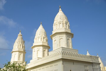  A serene Jain temple with intricate carvings and statues, radiating peace and spirituality. at...