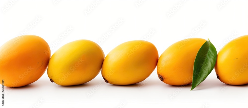 Poster Several mangoes on white surface with leaves and isolated mango fruit