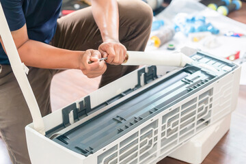 Fototapeta premium Technician man install new air conditioner, Male technician service for repair and maintenance of air conditioners