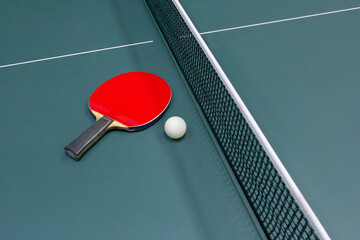 Table tennis ball and racket on the table - stock photo