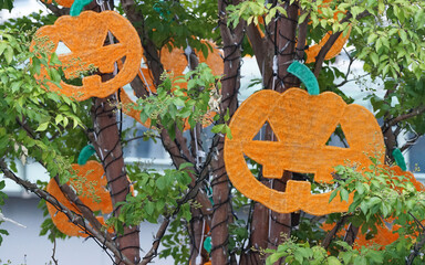 Many pumpkin haunted ornaments hung on trees during Halloween season