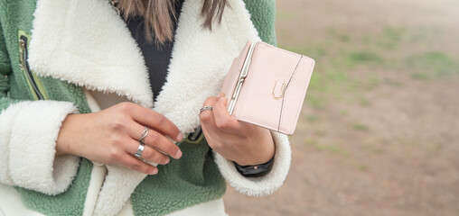 Young woman showing wallet. Fashion