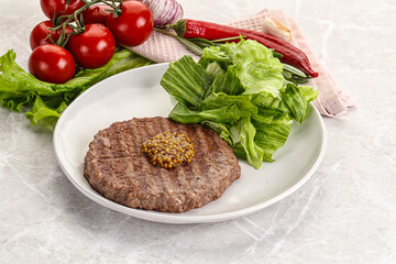 Frilled beef burger cutlet with iceberg