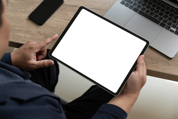 A businessman holds a mockup. iPad digital tablet with blank screen Mockup replaces your design...