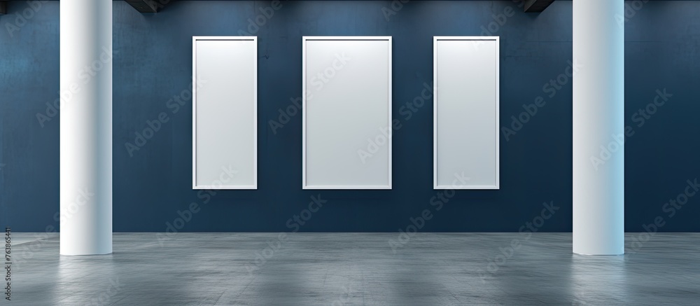 Poster three empty vertical frames in white are displayed on a wall painted in blue, complemented by a soli