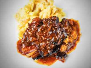 Baked juicy pork rib piece in spicy red sauce with mashed potato. - 763865480