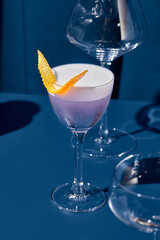 Whiskey sour cocktail in contemporary style on colorful background. Whiskey sour with egg foam on...