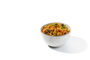 Asian fried noodles with shiitake mushrooms and vegetables isolated on white background Chinese fried noodles in vegetarian style in ceramic bowl. Stir-fry udon with vegetables and mushrooms