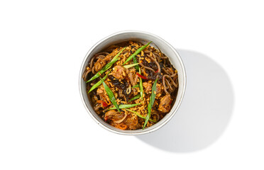 Asian fried buckwheat noodles with beef and vegetables isolated on white background. Japanese fried noodles teriyaki in ceramic bowl. Fried on wok soba with beef in minimal style. Wok menu.
