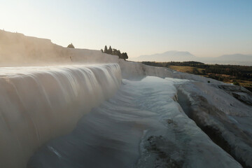 Steaming water running over a travertine terrace at Pamukkale in the early morning, Denizli, Turkey