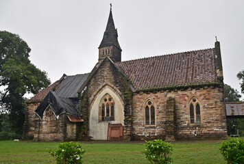 A peaceful church nestled among trees, complete with a bell tower and an inviting doorway,...