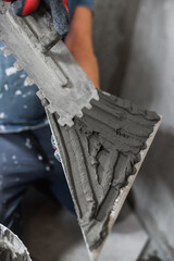 Professional qualified tiler work - installation of tiles on the floor and walls with diagonal cutting