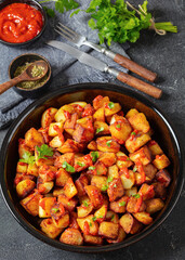 fried spanish potatoes with paprika sauce in bowl