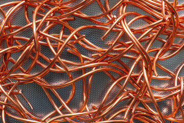 Shining copper wire on metal background, raw material and metallurgy industry