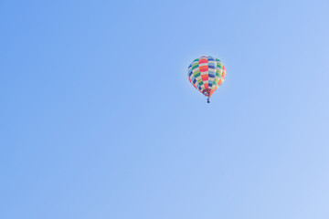 Hot air balloons landing in a mountain flight over field and forest,colorful Hot air balloons flying over the valley with blue sky,Tourism concept.