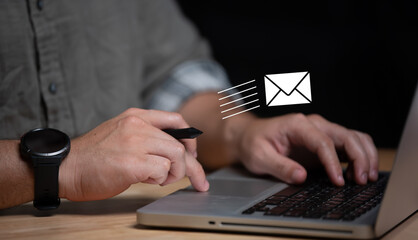 Businessman using laptop with popup icon email, newsletters and notification for business e-mail...