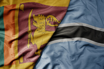 big waving national colorful flag of botswana and national flag of sri lanka .