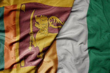 big waving national colorful flag of cote divoire and national flag of sri lanka .