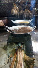 Making palm sugar traditionally by heating sap for 3-5 hours until it thickens, then molded into...