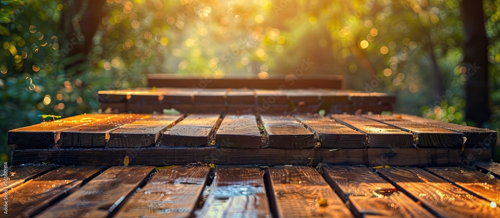Poster a wooden table is placed amidst a lush forest with sunlight filtering through the trees, creating a 