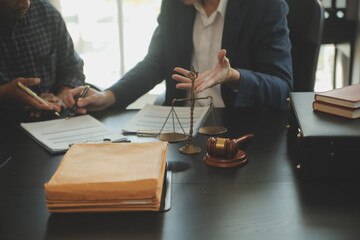 Justice and Law concept. Legal counsel presents to the client a signed contract with gavel and...