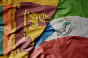 big waving national colorful flag of equatorial guinea and national flag of sri lanka .