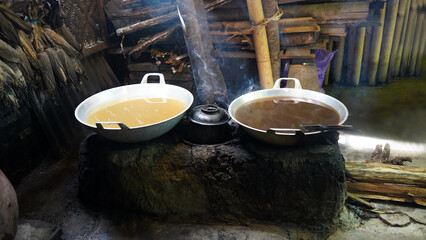 Making palm sugar traditionally by heating sap for 3-5 hours until it thickens, then molded into...