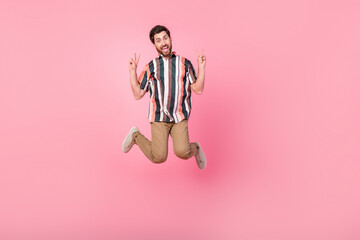 Fototapeta na wymiar Full body length size photo of jumping guy showing double v sign have fun sale week black friday isolated on pink color background