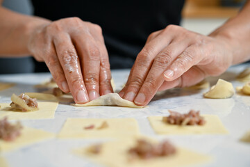Female hands making Turkish dumpling   Homemade Turkish manti
