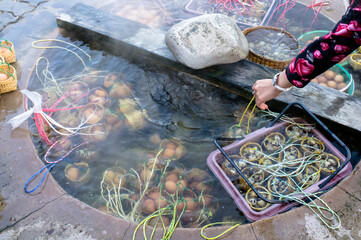eggs boiling in a hot spring pool in Lampang province of Thailand.