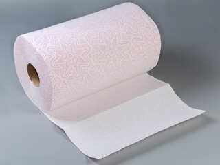 Roll of tear-off paper towels on a gray surface