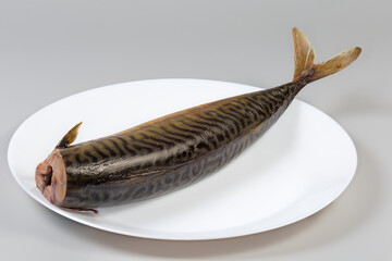 Whole cold-smoked Atlantic mackerel without head on a dish