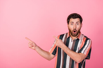 Portrait of speechless person open mouth cant believe direct fingers empty space isolated on pink color background - obrazy, fototapety, plakaty