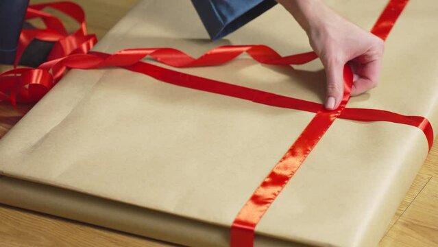 Trying on red ribbon and gluing it to craft