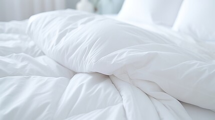 White folded duvet lying on white bed background. Preparing for winter season, household, domestic activities, hotel or home textile - obrazy, fototapety, plakaty