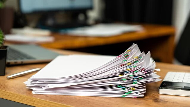 Stack overload report docs with documentation increase. Accounting workplace with laptop and calculator at office