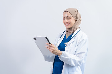 Attractive Middle aged muslim female doctor pediatric, physical or psychiatrist with headscarf in white coat with stethoscope standing on white background, virus, health care, disease treatment
