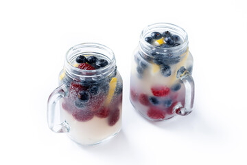Fresh berry drink with blueberries and raspberries and lemon isolated on white background