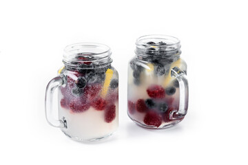 Fresh berry drink with blueberries and raspberries and lemon isolated on white background