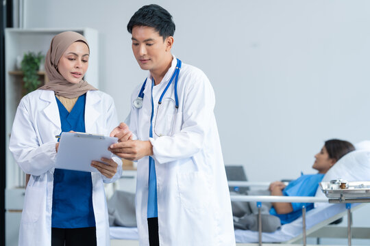 Two conficent doctor or specialist of kidney cancer talking together with female mix race patient on bed at medical ward, checkup, recovering after successful surgery concept.